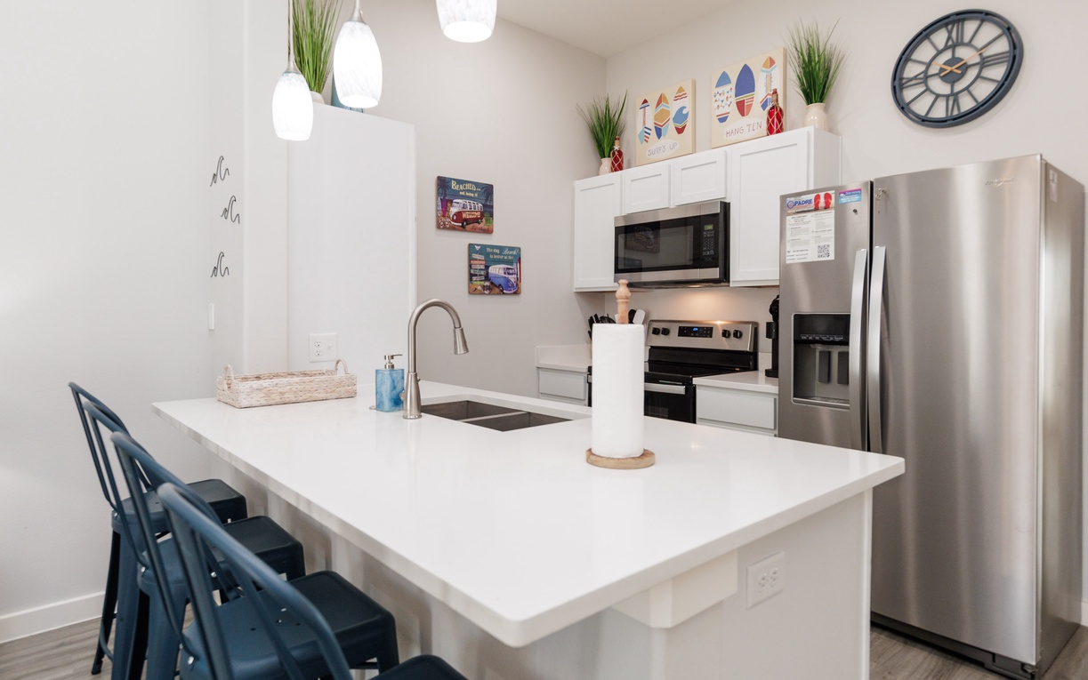 Your fully-equipped kitchen features modern appliances and a spacious island perfect for cooking meals and gathering with loved ones during your stay.