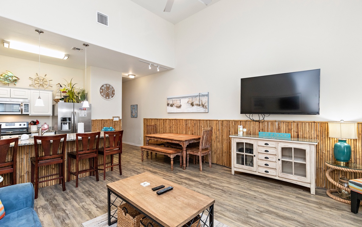 Relax in your open-concept living space with bamboo accents, vaulted ceilings, and coastal charm perfect for memorable vacation moments.