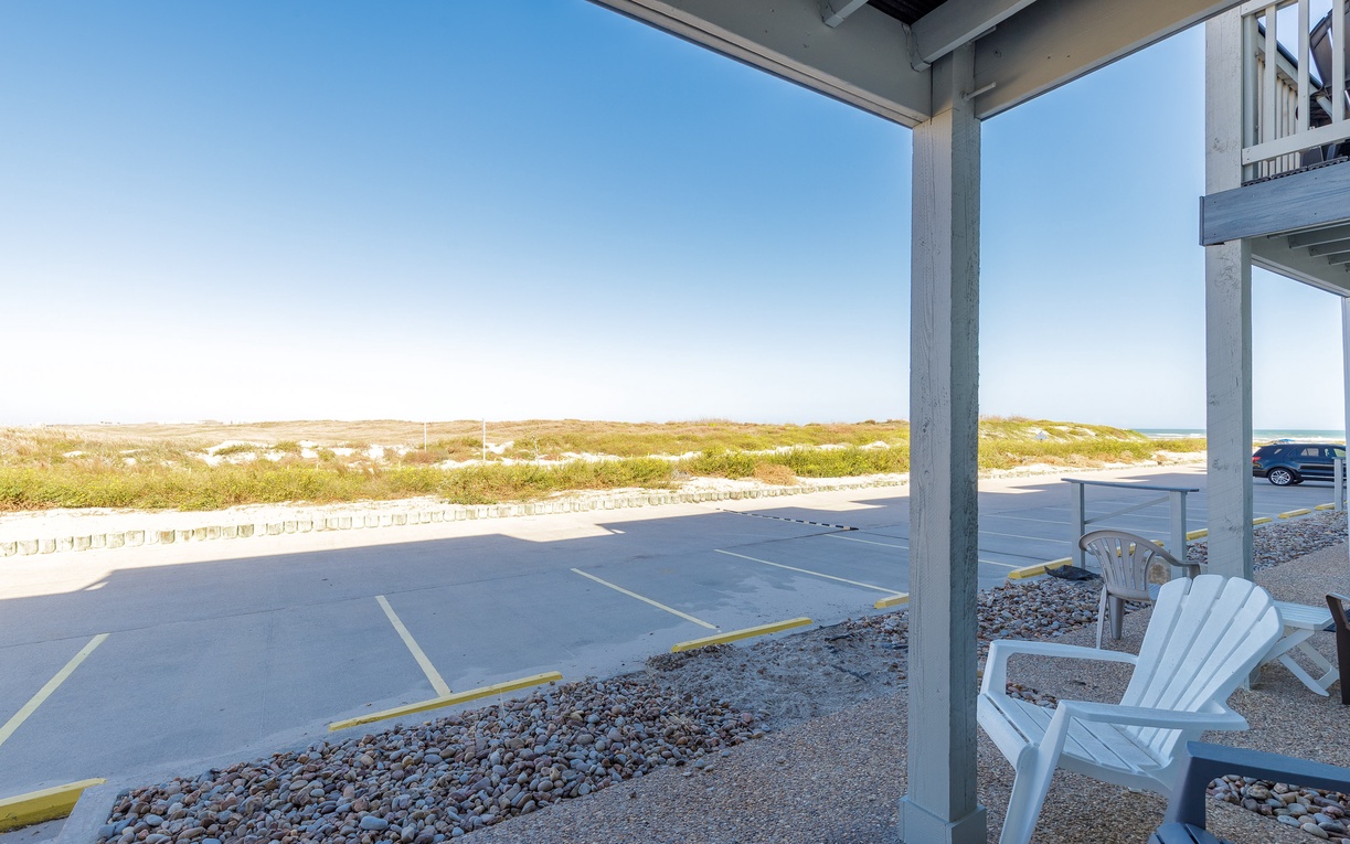 Relax in your Adirondack chairs on the covered patio, watching coastal views unfold beyond the dunes.