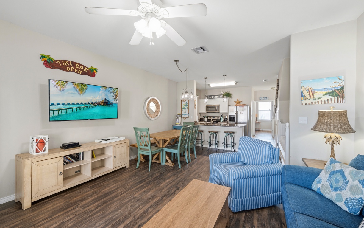 Relax in your open-concept living space, where ceiling fans keep you comfortable while you gather around the dining table or unwind on the sofa, with the kitchen just steps away for easy entertaining.