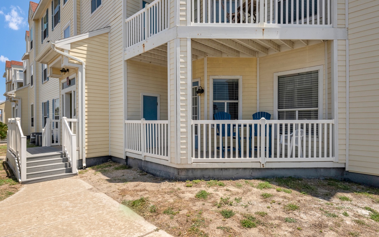 Bright beachside property with multi-level balconies and coastal architecture in a peaceful residential area.