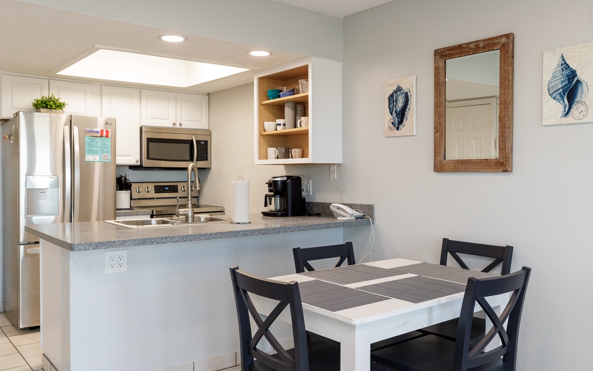 Prepare your favorite meals in this fully-equipped kitchen with granite countertops, stainless appliances, and open breakfast bar seating.