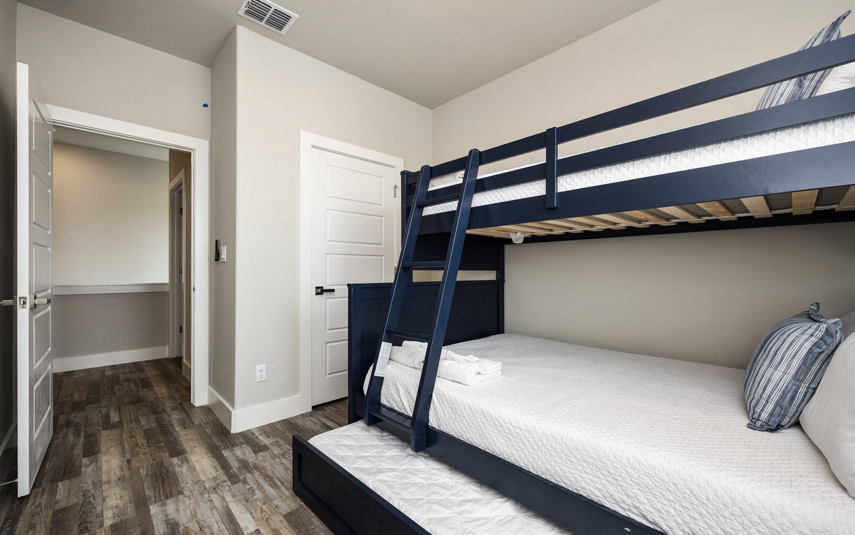 Your family will love this stylish bunk room with navy beds and crisp white linens, perfect for kids' adventures.