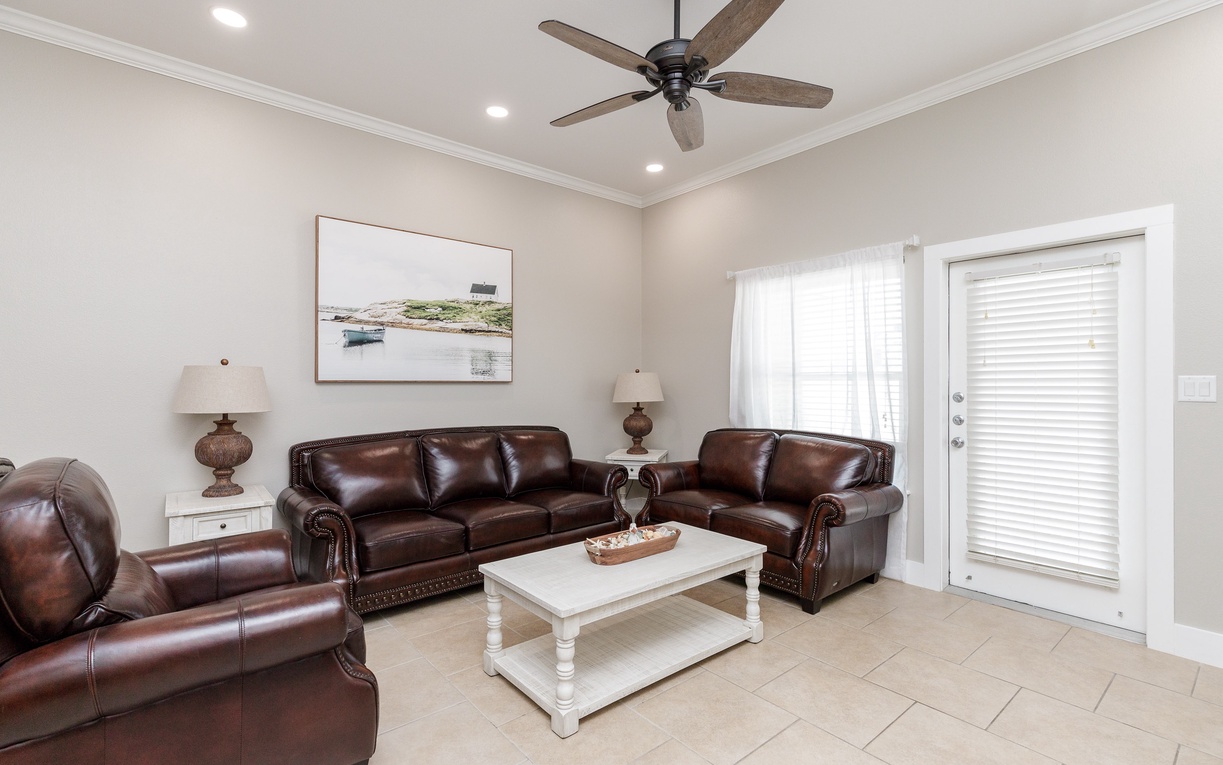 Your spacious living room features rich leather seating and a coastal-themed atmosphere, perfect for unwinding after your adventures.