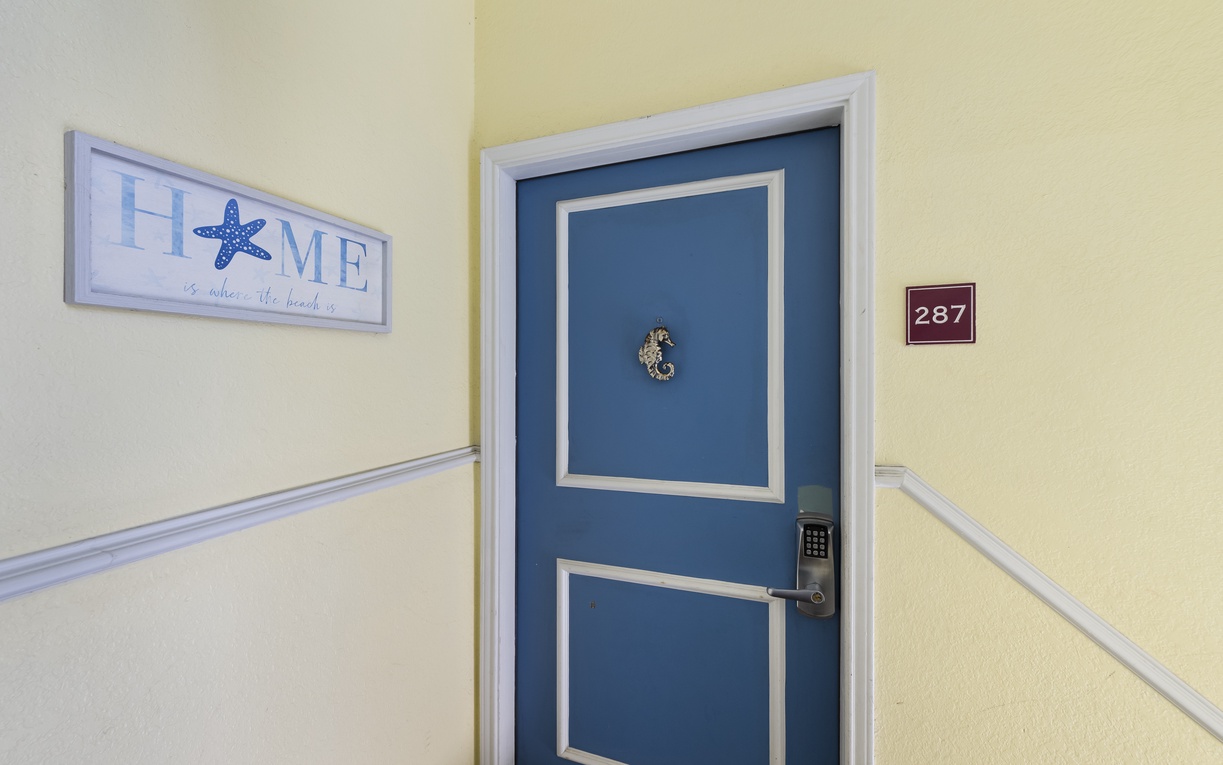 Step into your charming retreat through this welcoming blue door, where warm yellow walls and thoughtful details create your perfect getaway.