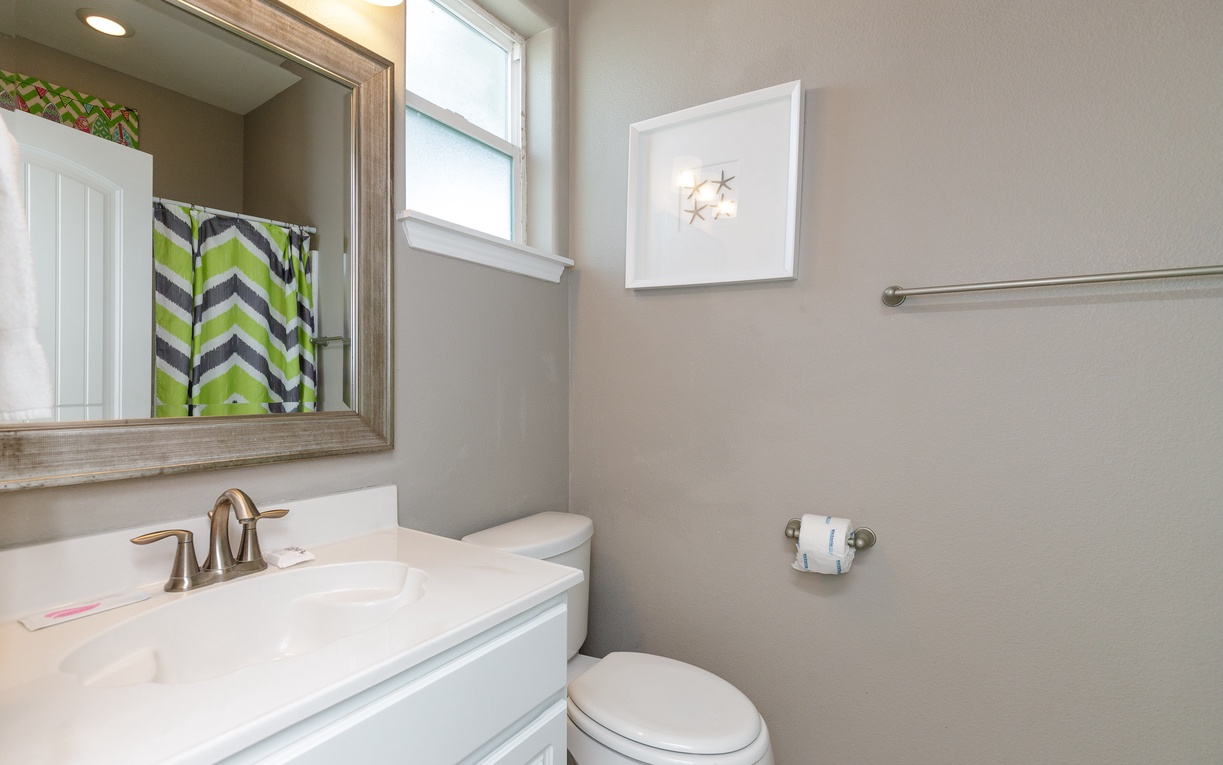 Your private bathroom features modern vanity, bright lighting, and cheerful chevron accents for refreshing morning routines.