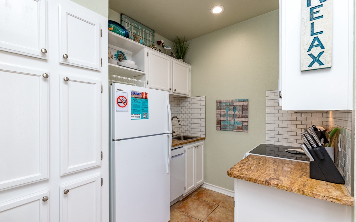 Your fully-equipped kitchen awaits with granite counters, subway tile backsplash, and everything needed to create memorable meals during your stay.