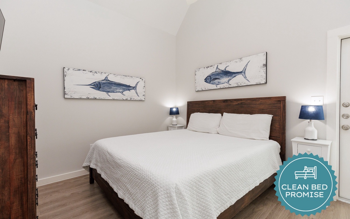 Drift off to peaceful sleep in your coastal-inspired bedroom, complete with nautical artwork and cozy bedside lighting.
