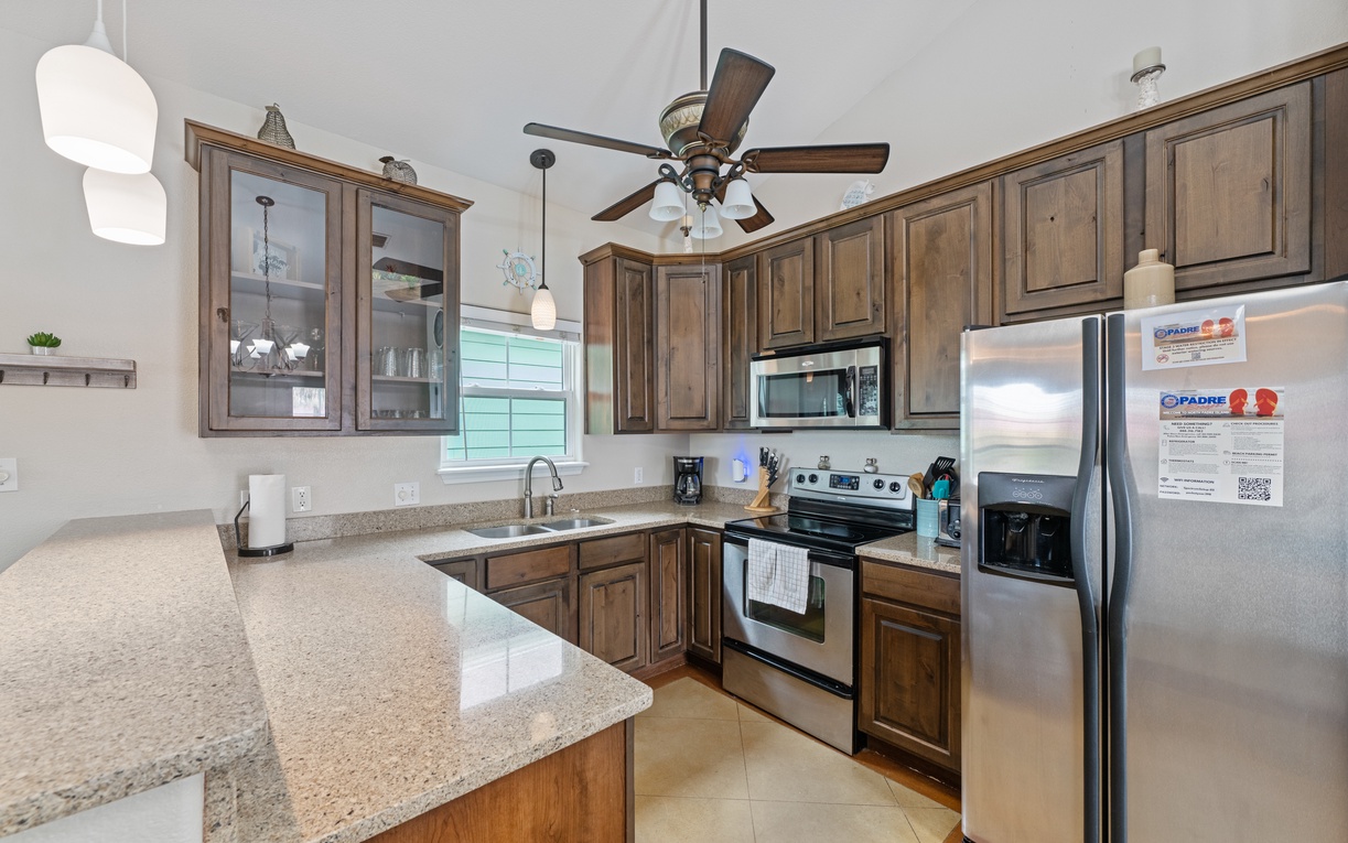 Cook comfortably in your fully equipped kitchen featuring granite countertops, stainless steel appliances, and ample cabinet space.