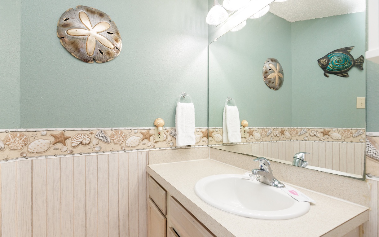 Refresh in your coastal-themed bathroom featuring charming sea life decor and elegant fixtures for your comfort.