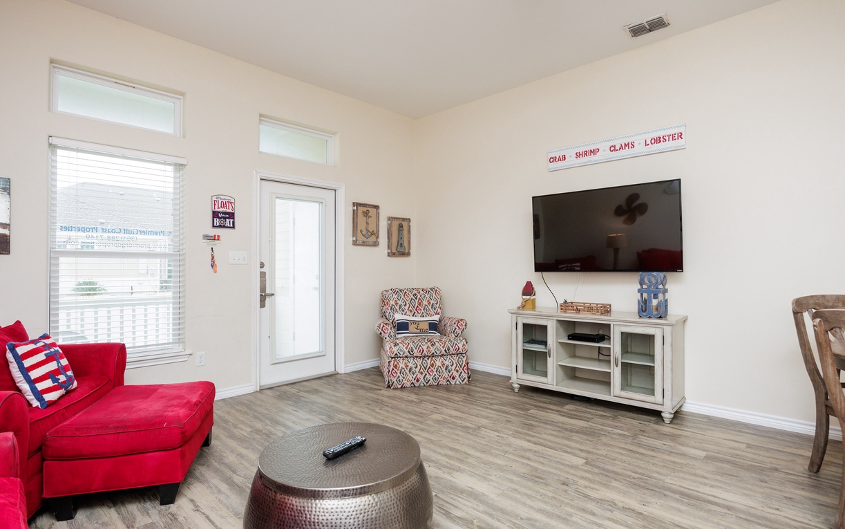 Relax in your bright coastal-themed living space with comfortable seating, flat-screen TV, and charming nautical touches throughout.