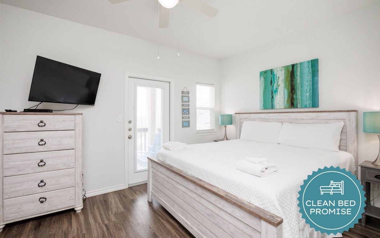 Unwind in your serene bedroom with coastal artwork, fresh linens, and a private balcony for morning coffee moments.