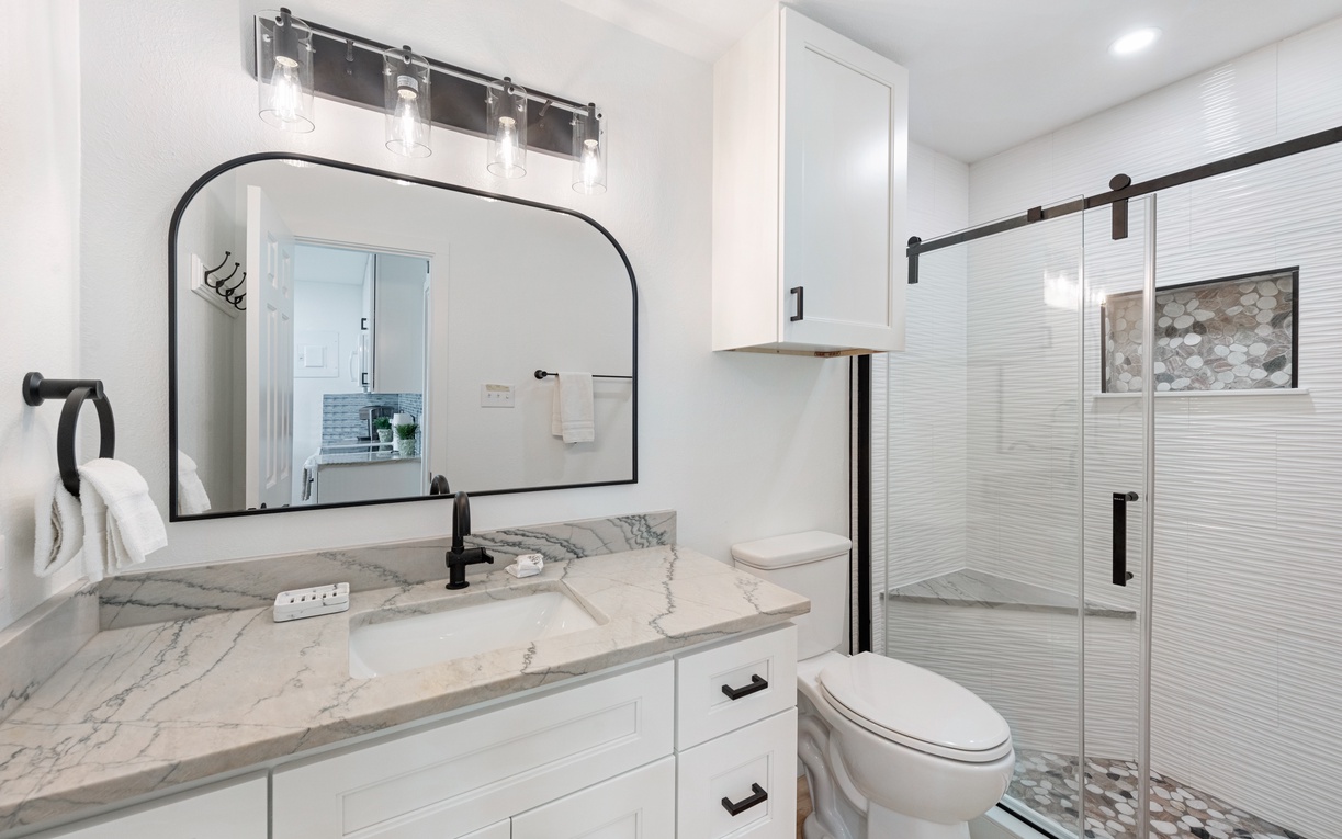 Step into your spa-like retreat with elegant marble counters, modern fixtures, and a luxurious walk-in shower perfect for unwinding.
