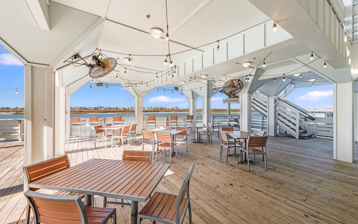 Stunning waterfront deck with panoramic views, perfect for seaside dining and memorable meals.