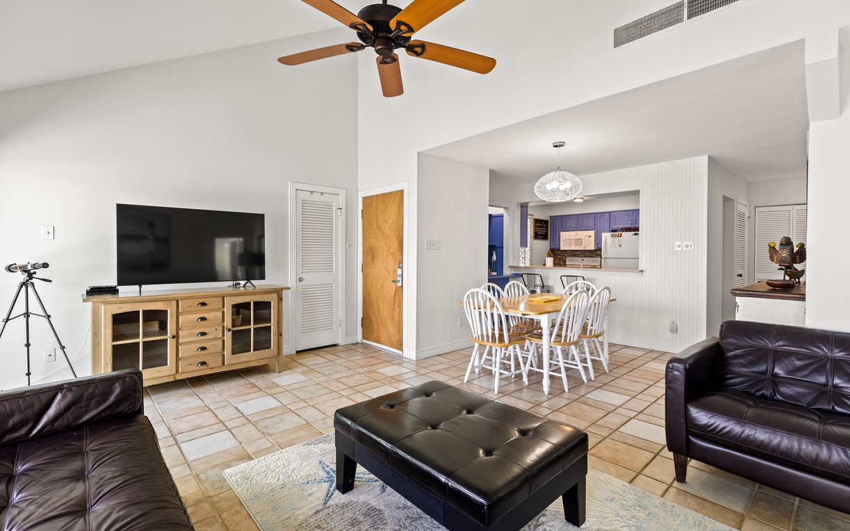 Unwind in your spacious living area with leather seating, ceiling fan, and open kitchen perfect for memorable meals together.