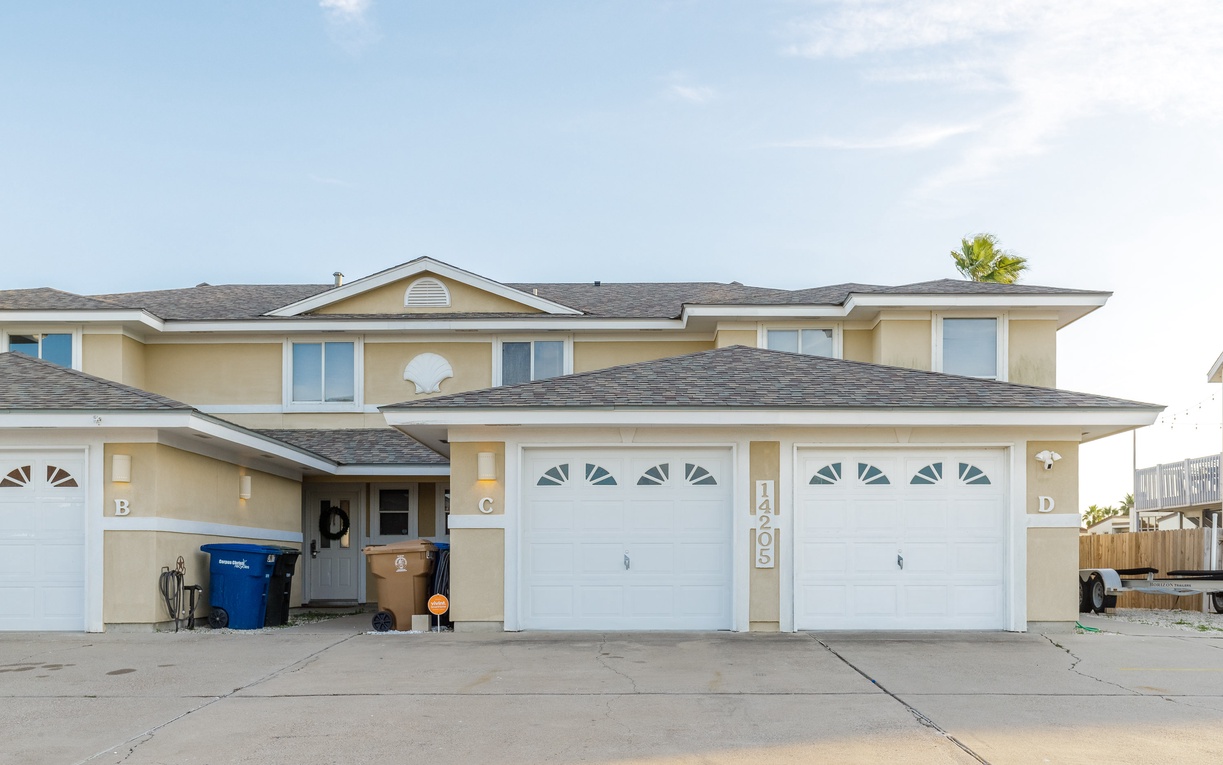 Modern two-story townhouse with driveway parking in a quiet residential neighborhood.