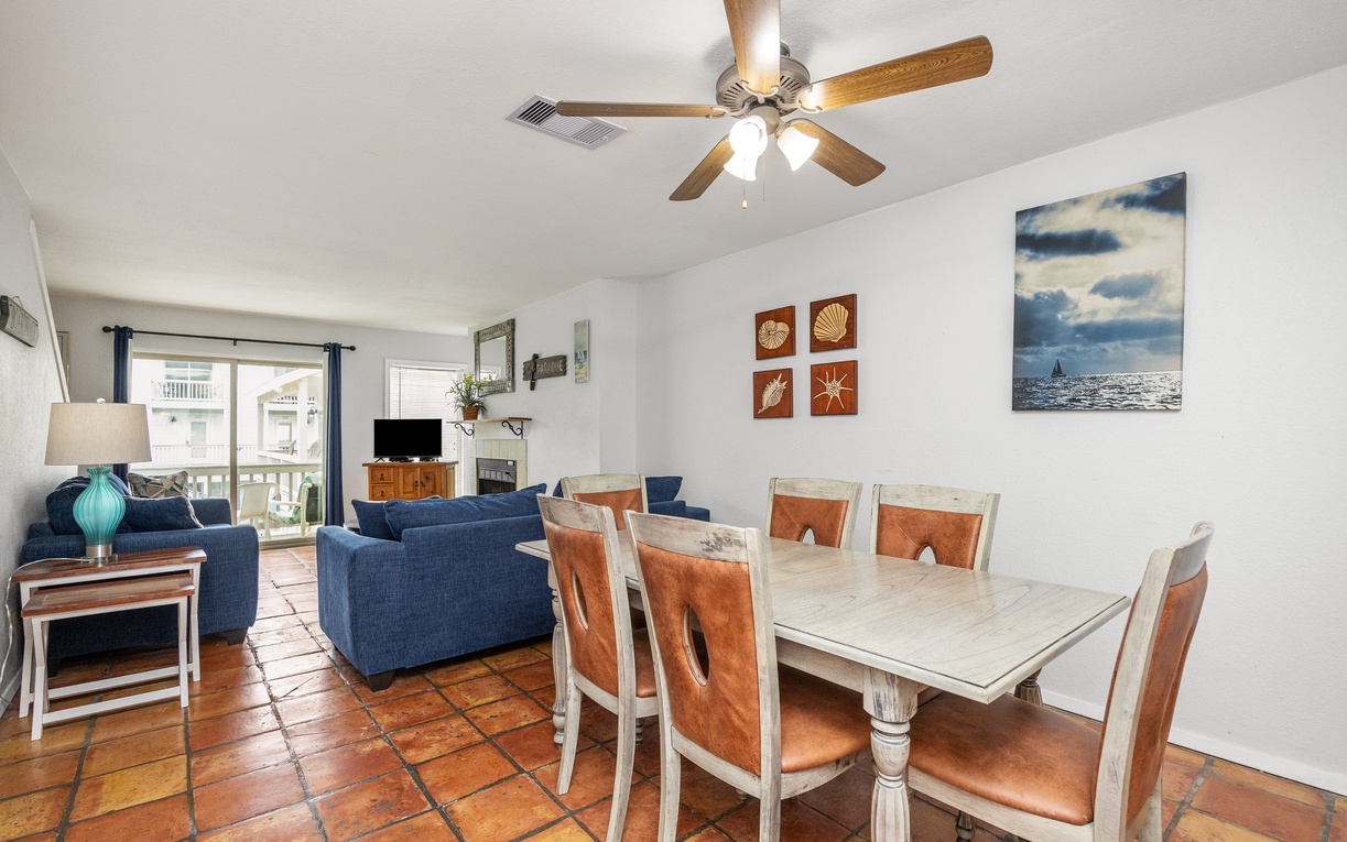 Gather around your spacious dining table for eight, where coastal charm meets comfort beneath the gentle breeze of your ceiling fan.