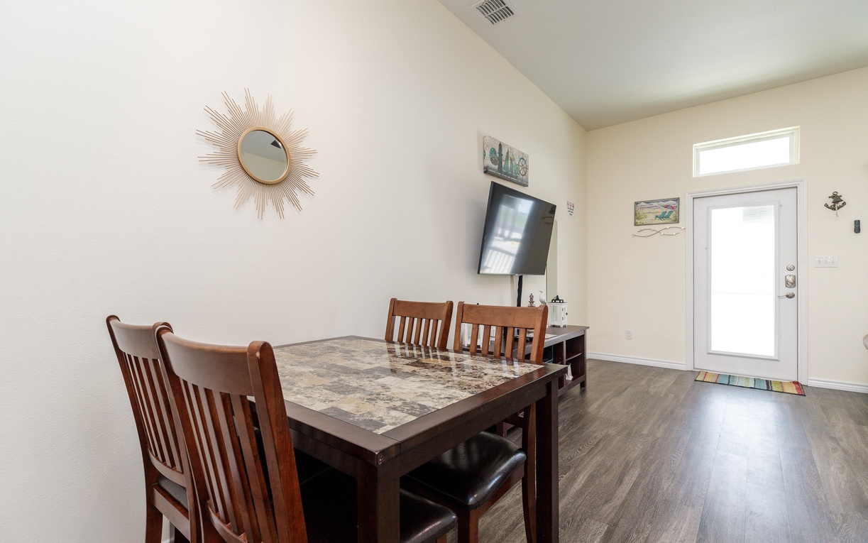 Gather around your stylish dining table for memorable meals, with entertainment ready on the wall-mounted TV.