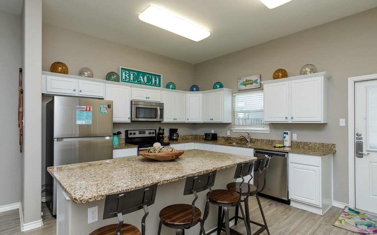 Your fully equipped kitchen features granite countertops, stainless appliances, and breakfast bar seating where you'll gather for morning coffee and memorable meals together.