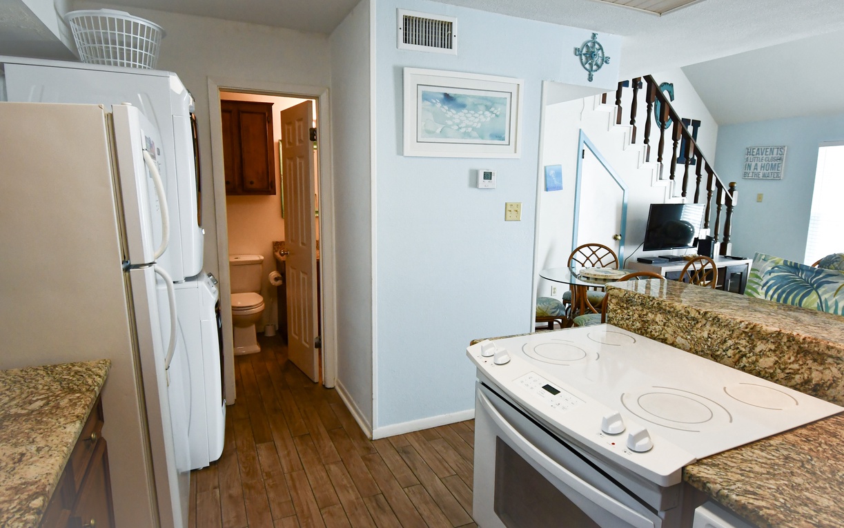 Your fully-equipped kitchen features granite countertops, modern appliances, and coastal charm—perfect for preparing meals during your beach getaway.