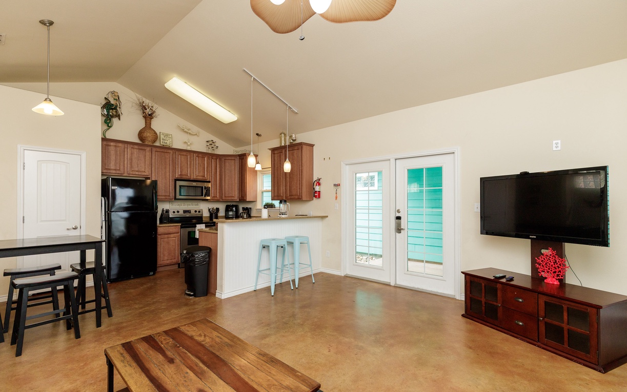 Relax in your open-concept living space with vaulted ceilings, complete kitchen, and entertainment area perfect for memorable evenings.