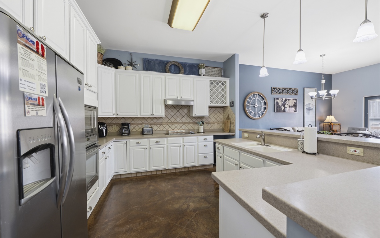 Your spacious kitchen features gleaming white cabinetry, modern stainless appliances, and ample counter space perfect for whipping up vacation meals together with family and friends.