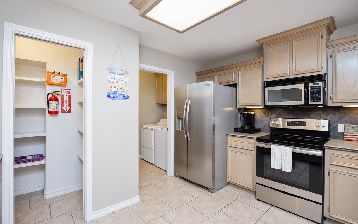 Your fully equipped kitchen features stainless steel appliances and a bright skylight that fills the space with natural light while you cook.