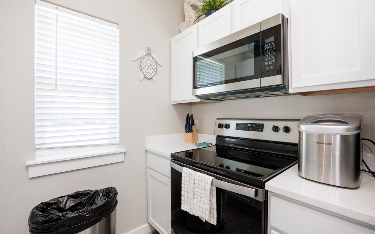 Your fully-equipped kitchen awaits with modern stainless steel appliances, bright natural light, and everything you need to create delicious meals during your stay.