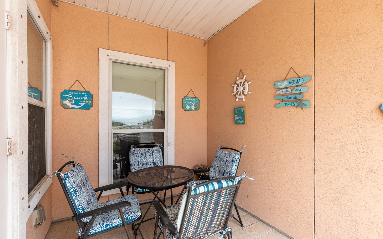 Your private patio offers the perfect coastal retreat with comfortable seating and charming beach-themed decor to start your mornings.
