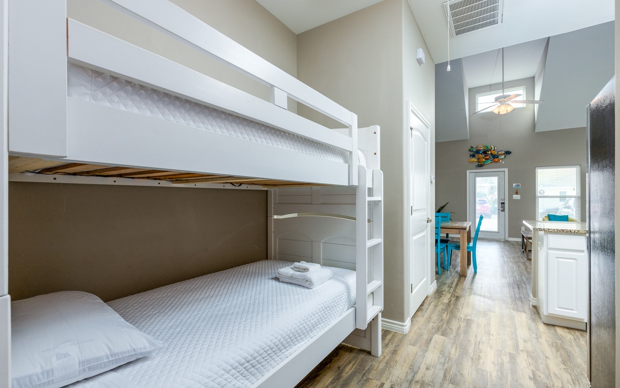 Your kids will love this cozy bunk bed setup, complete with fresh linens and easy access to the kitchen.