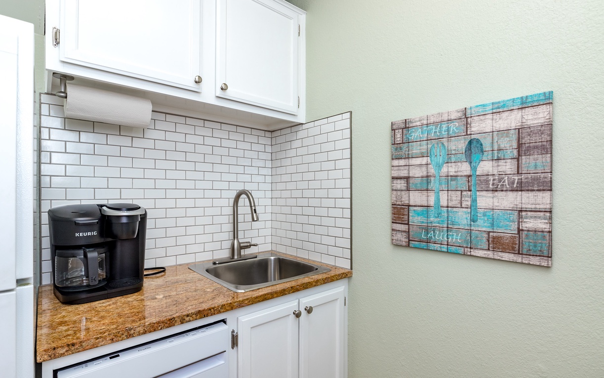 Start your mornings right in your charming kitchenette with fresh coffee from the Keurig, granite counters, and cheerful coastal artwork.
