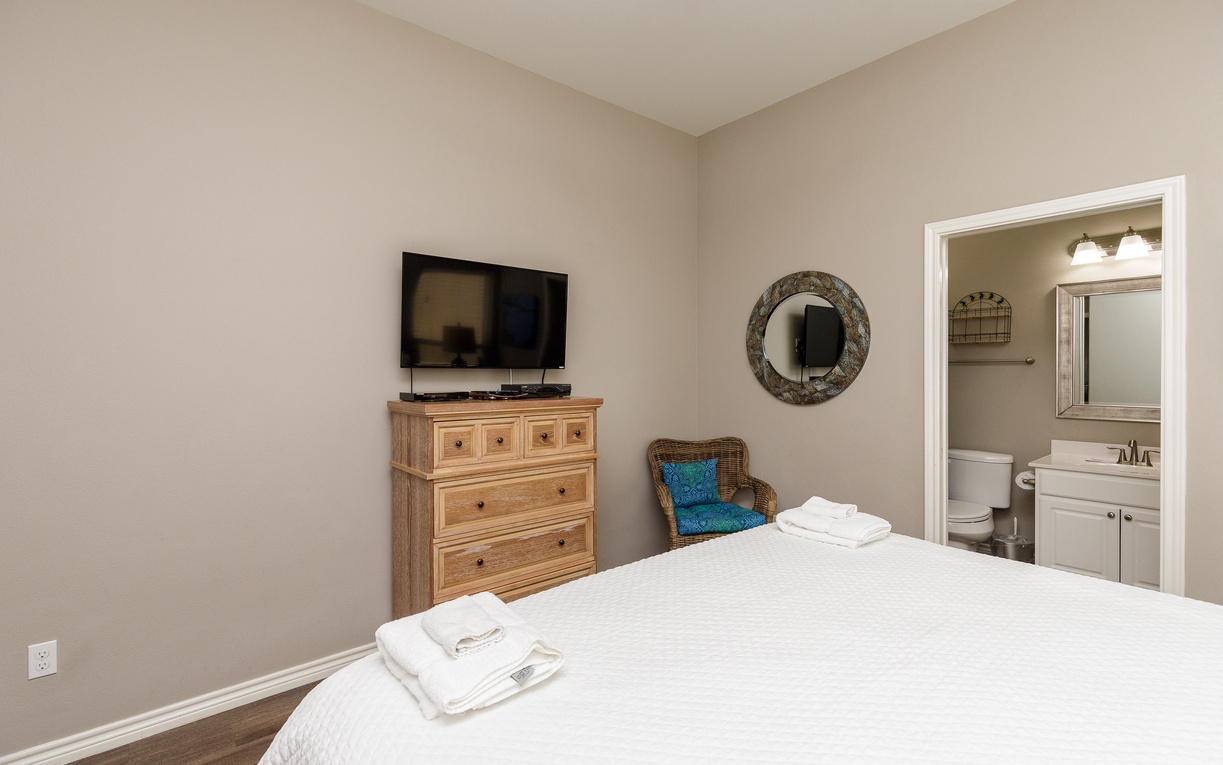Unwind in your comfortable bedroom with plush linens, modern TV, and an ensuite bathroom for complete privacy and convenience.