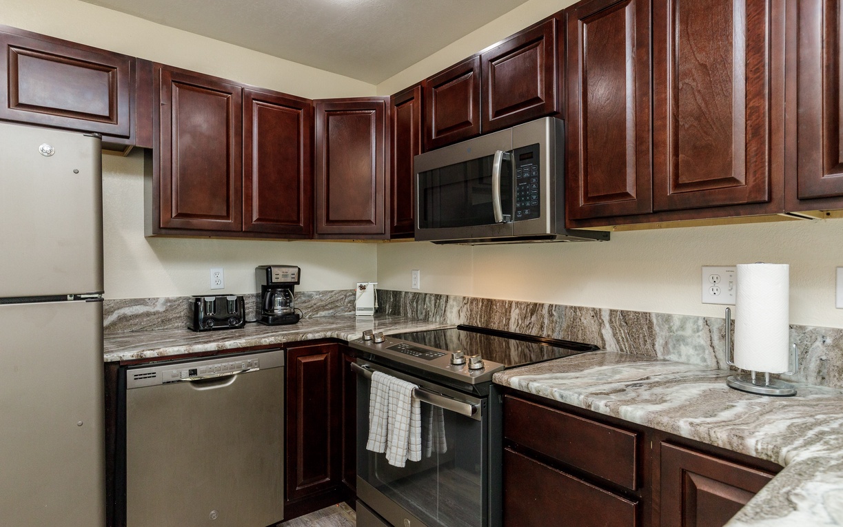 Your fully equipped kitchen features rich cherry cabinets, granite counters, and everything you need to prepare meals during your stay.