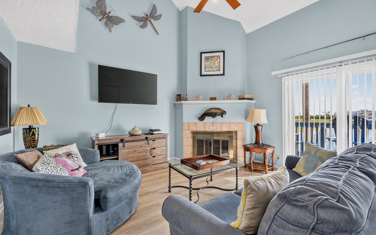 Relax in your spacious living room with vaulted ceilings, a cozy fireplace, and comfortable seating perfect for unwinding after a day of exploring.