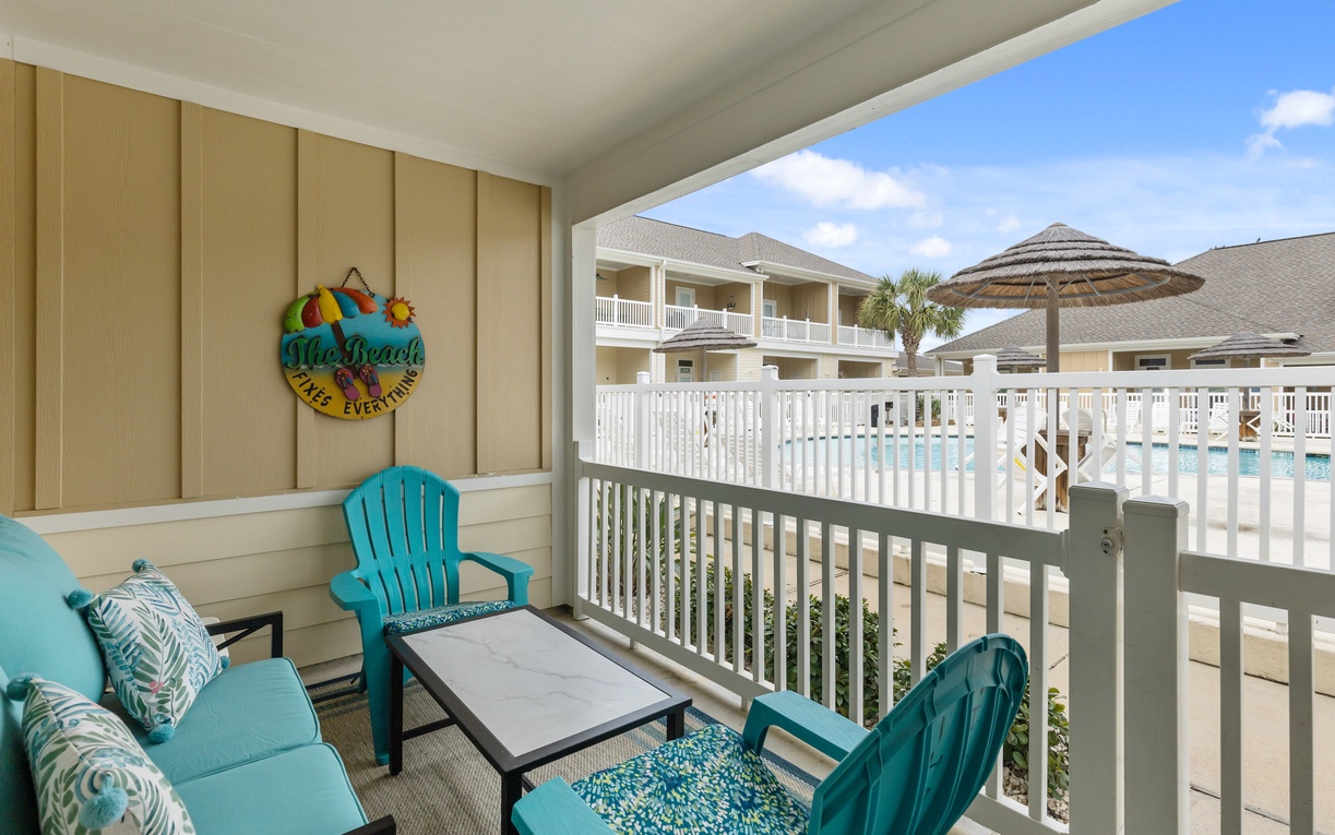 Relax in your private patio with plush turquoise seating overlooking the sparkling pool area.