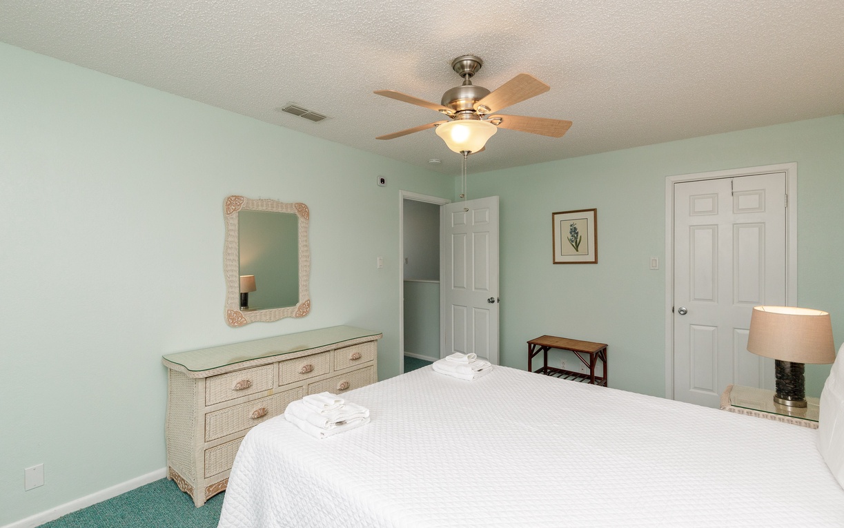 Unwind in your guest bedroom featuring a queen size bed.