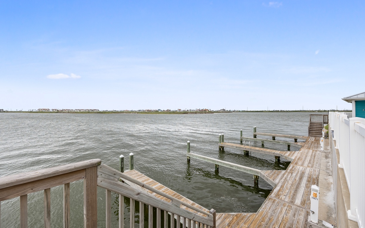 Waterfront property featuring a private dock with expansive bay views and distant shoreline.