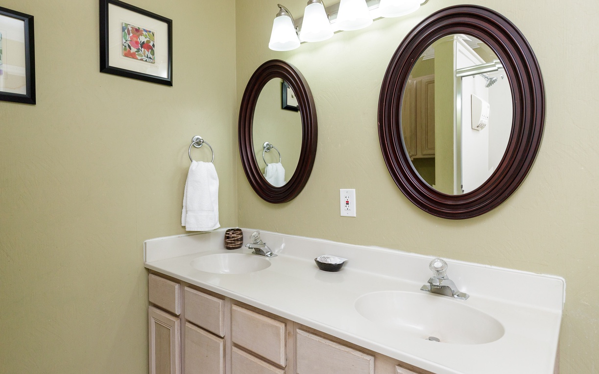 Get ready in style with this spacious double vanity featuring elegant mirrors and ample counter space for your morning routine.