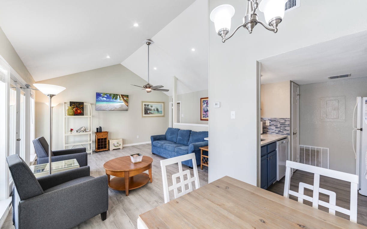 Your spacious open-plan living area combines comfort and style with vaulted ceilings, cozy seating, and a fully equipped kitchen for memorable meals.