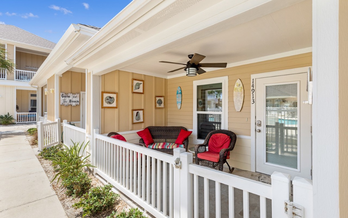 Relax on your private covered porch with coastal charm and comfy seating—perfect for morning coffee or evening conversations.