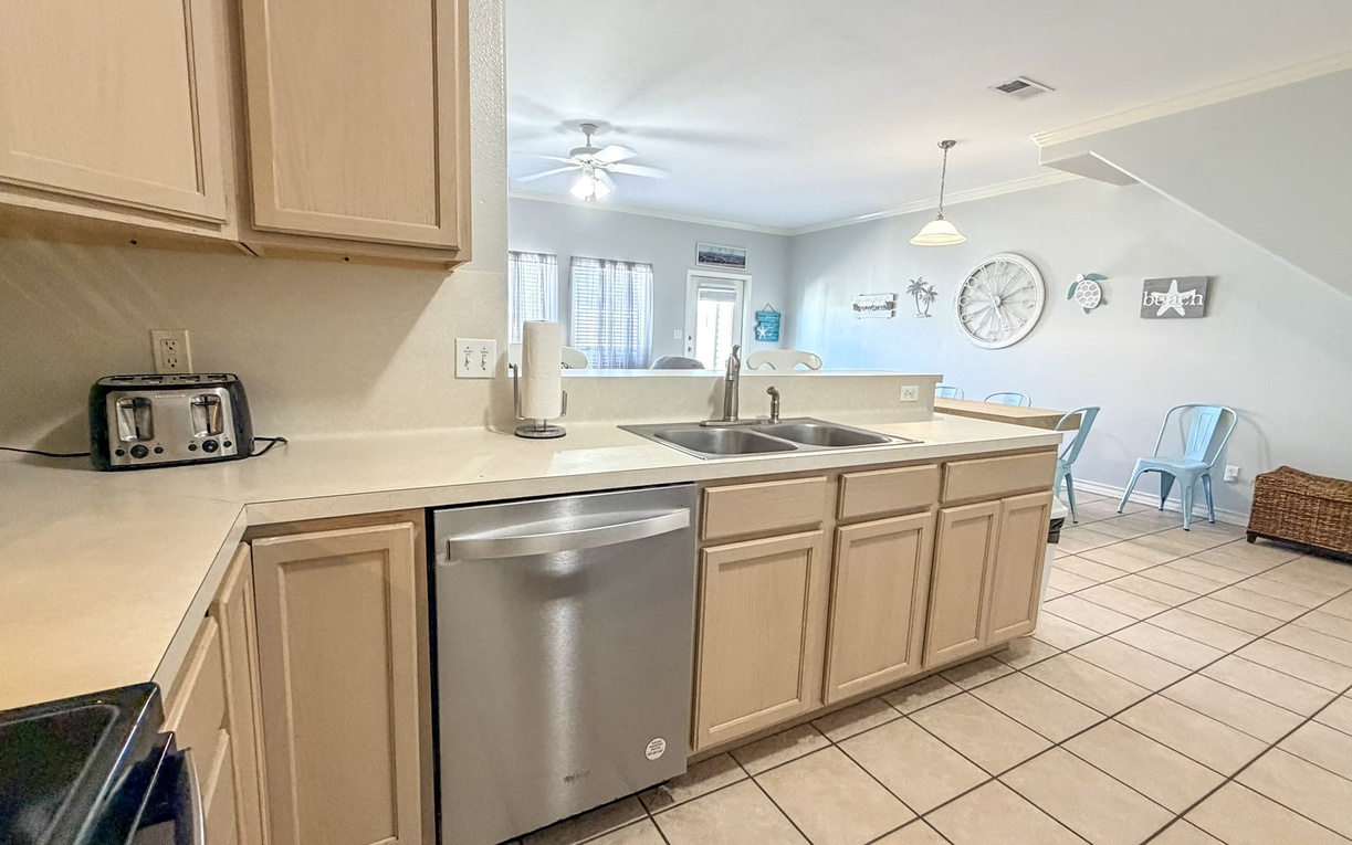 Your fully equipped kitchen features modern appliances and opens to your bright dining space, perfect for preparing meals and gathering together.