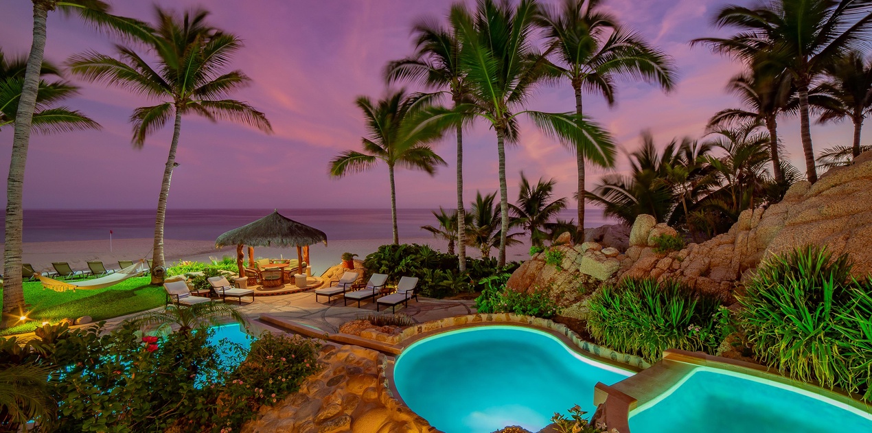 Gorgeous patio with pool and beach view during sunset
