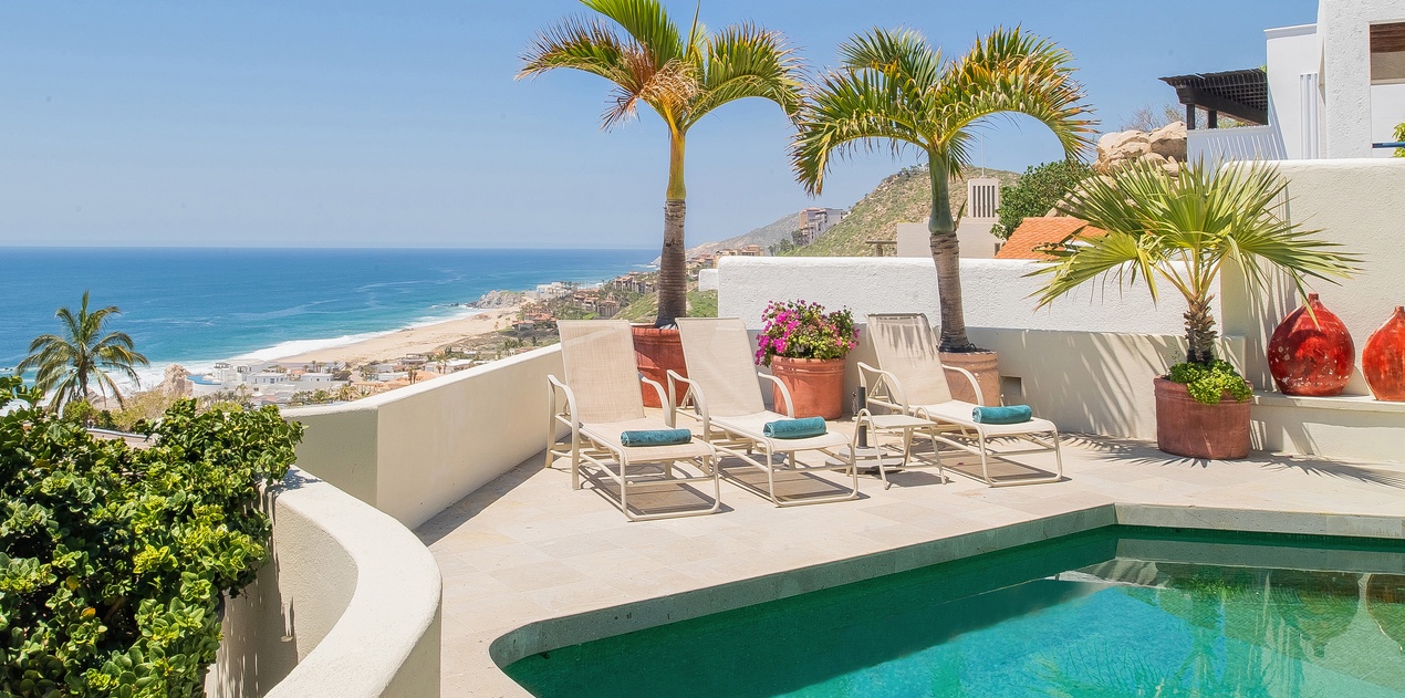 Sunny pool side with ocean view