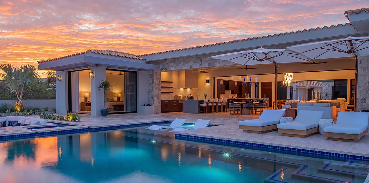 Stunning sunset views frame this luxurious property, where your private pool beckons under painted skies. Sink into poolside loungers as twilight hues dance across the water, casting a warm glow over your open-air retreat.