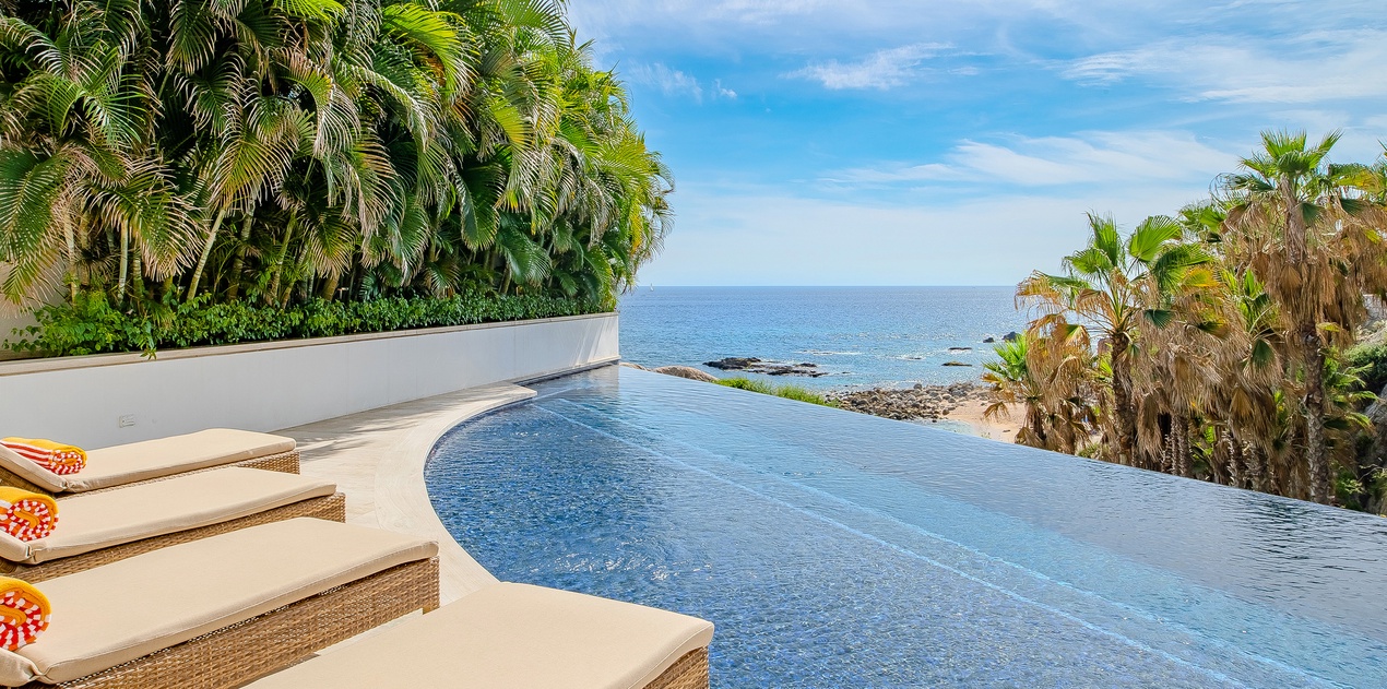 Swim in your private infinity pool while palm trees sway and endless ocean views stretch to the horizon.