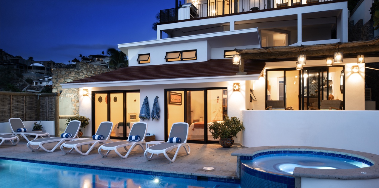Modern villa with pool and hot tub creates perfect evening ambiance for relaxation under the stars.