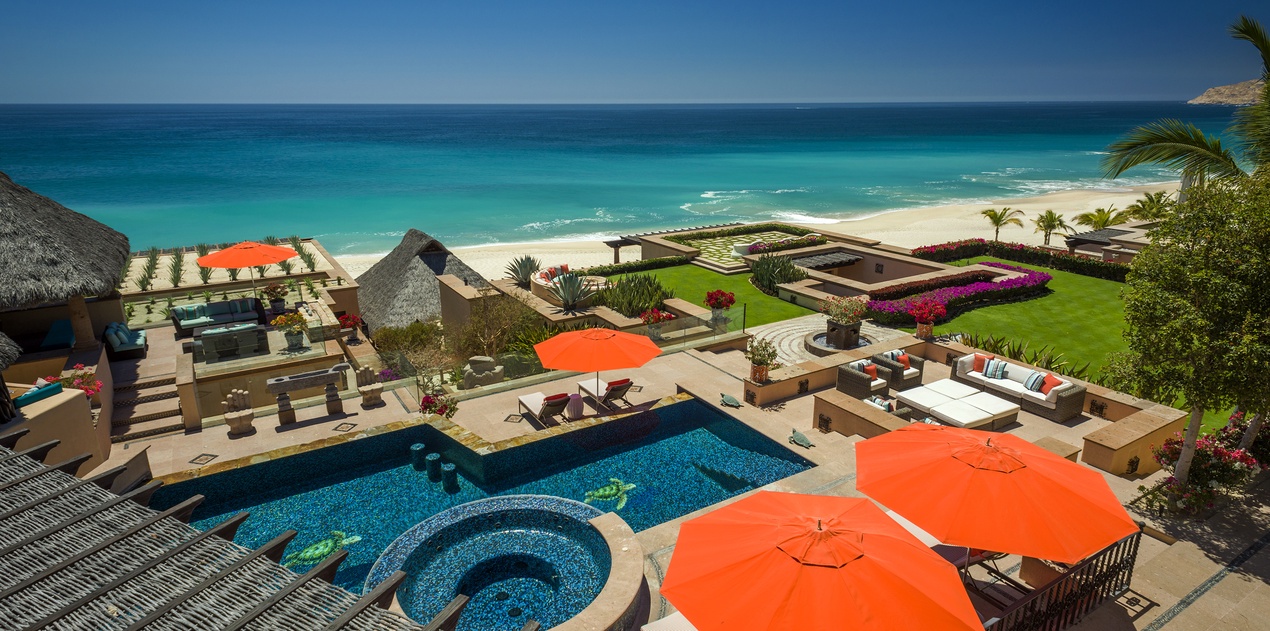 Stunning beachfront villa featuring pool, spa, and pristine beach access with vibrant tropical gardens and ocean views.