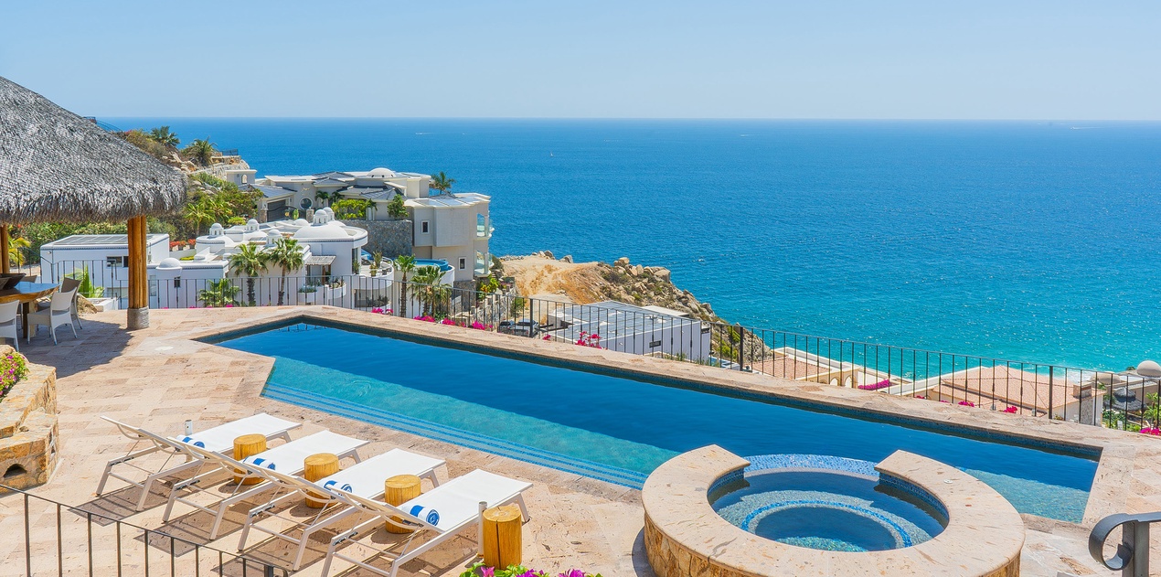 Breathtaking infinity pool overlooking crystal-clear waters, perfect for soaking up sun while enjoying panoramic ocean views.