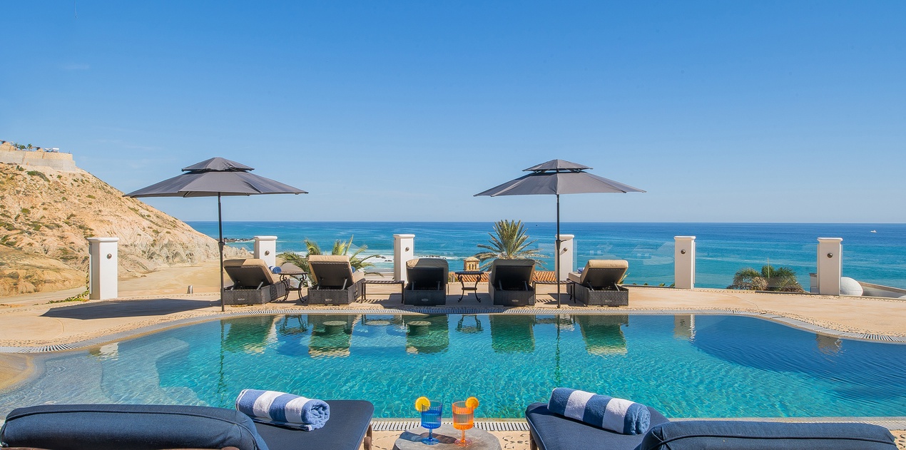 Sunny poolside patio overlooking an incredible ocean view