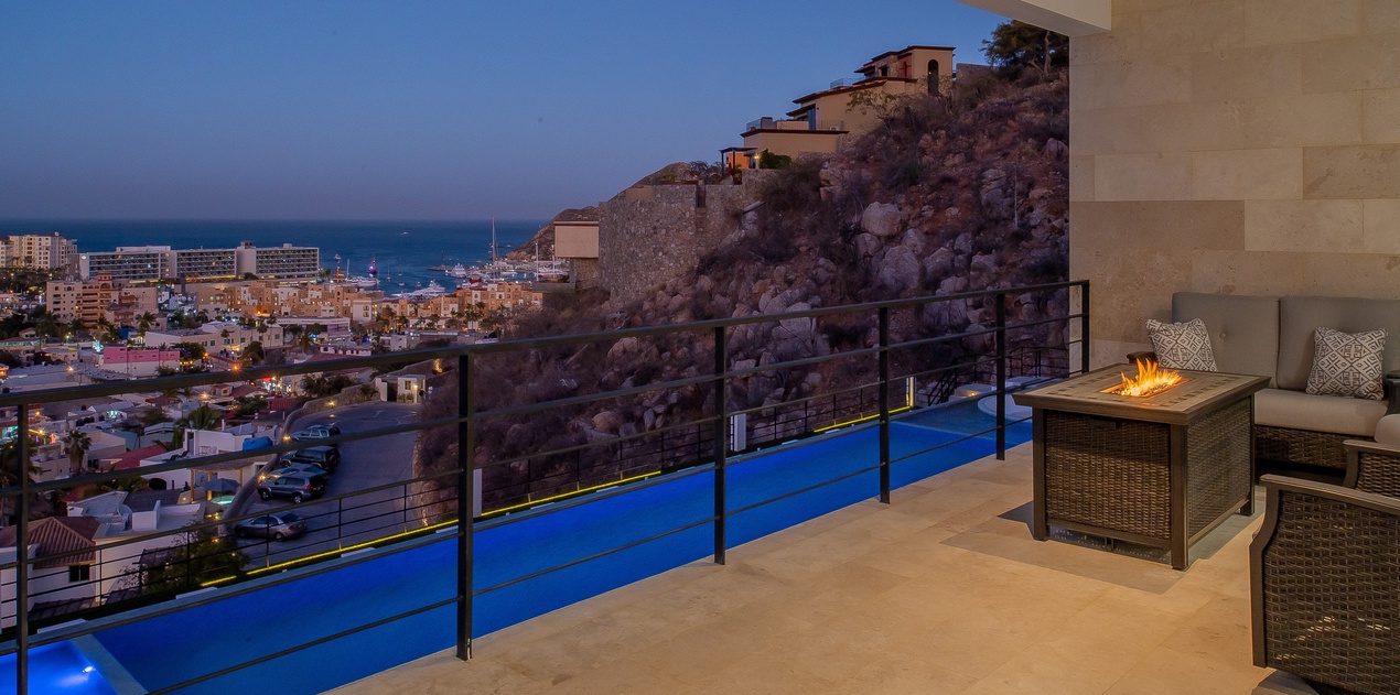 Terrace with city and ocean view at night